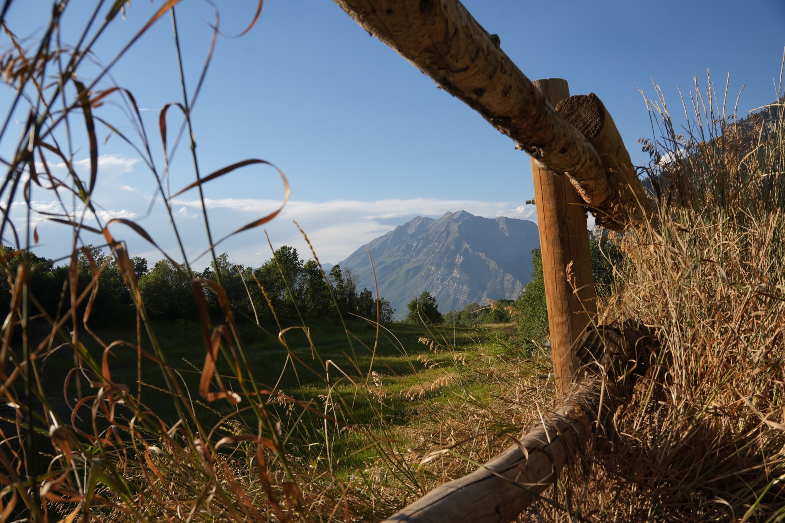 Split-rail fence framing a view of Mount Timpanogos in Utah, captured by Apex Visuals LLC